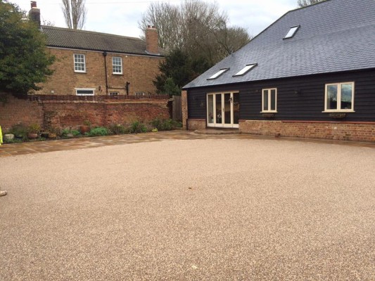 New resin bound driveway with Indian sandstone setts and patio slab area to match.