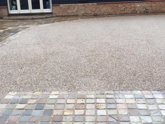 New resin bound driveway with Indian sandstone setts and patio slab area to match.