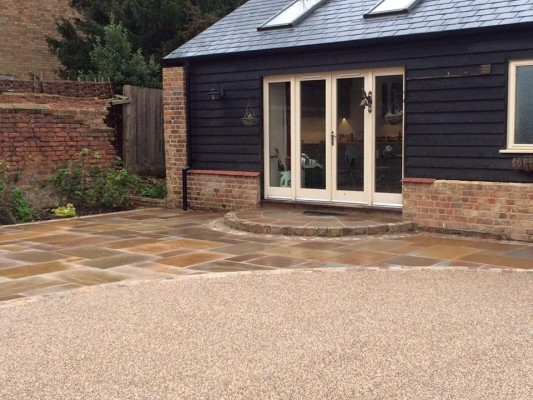 New resin bound driveway with Indian sandstone setts and patio slab area to match.