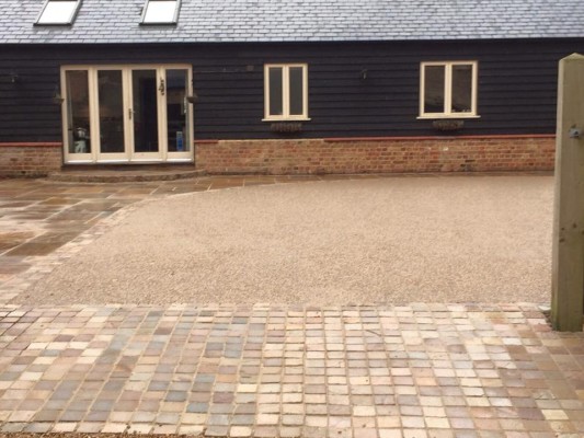 New resin bound driveway with Indian sandstone setts and patio slab area to match.