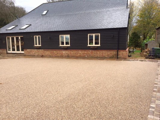 New resin bound driveway with Indian sandstone setts and patio slab area to match.