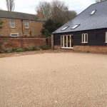 New resin bound driveway with Indian sandstone setts and patio slab area to match.